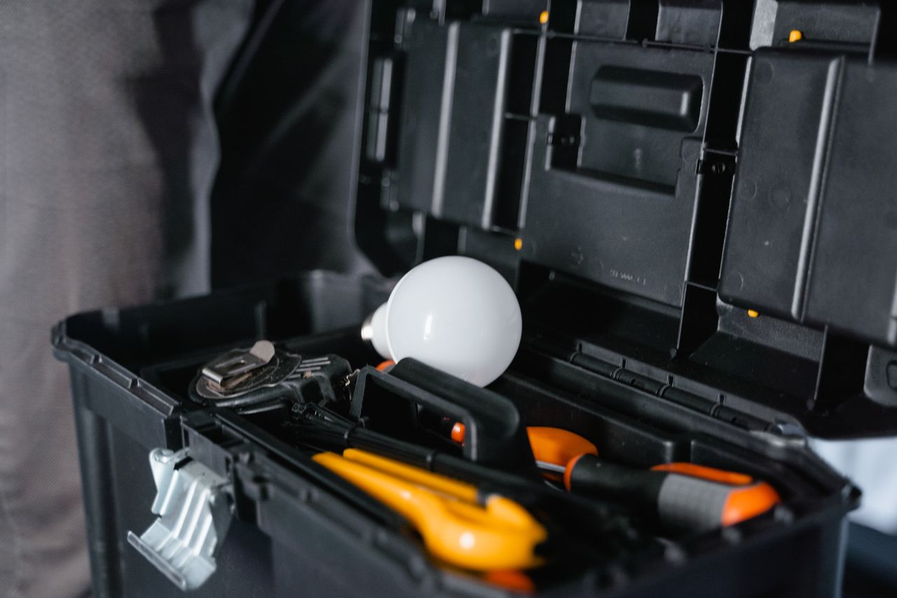 digital Open toolbox containing various tools and a light bulb.