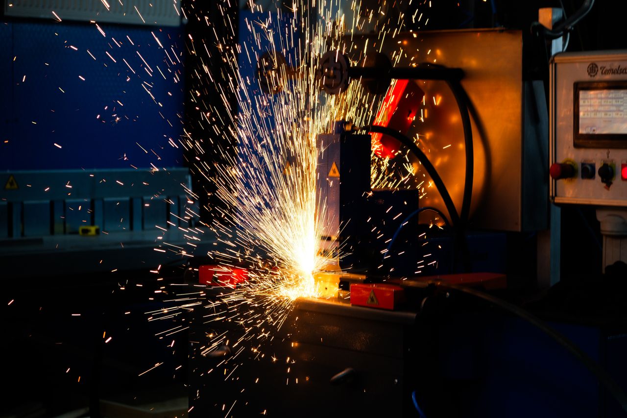 services-01 Vibrant display of welding sparks in an industrial setting, highlighting manufacturing processes.