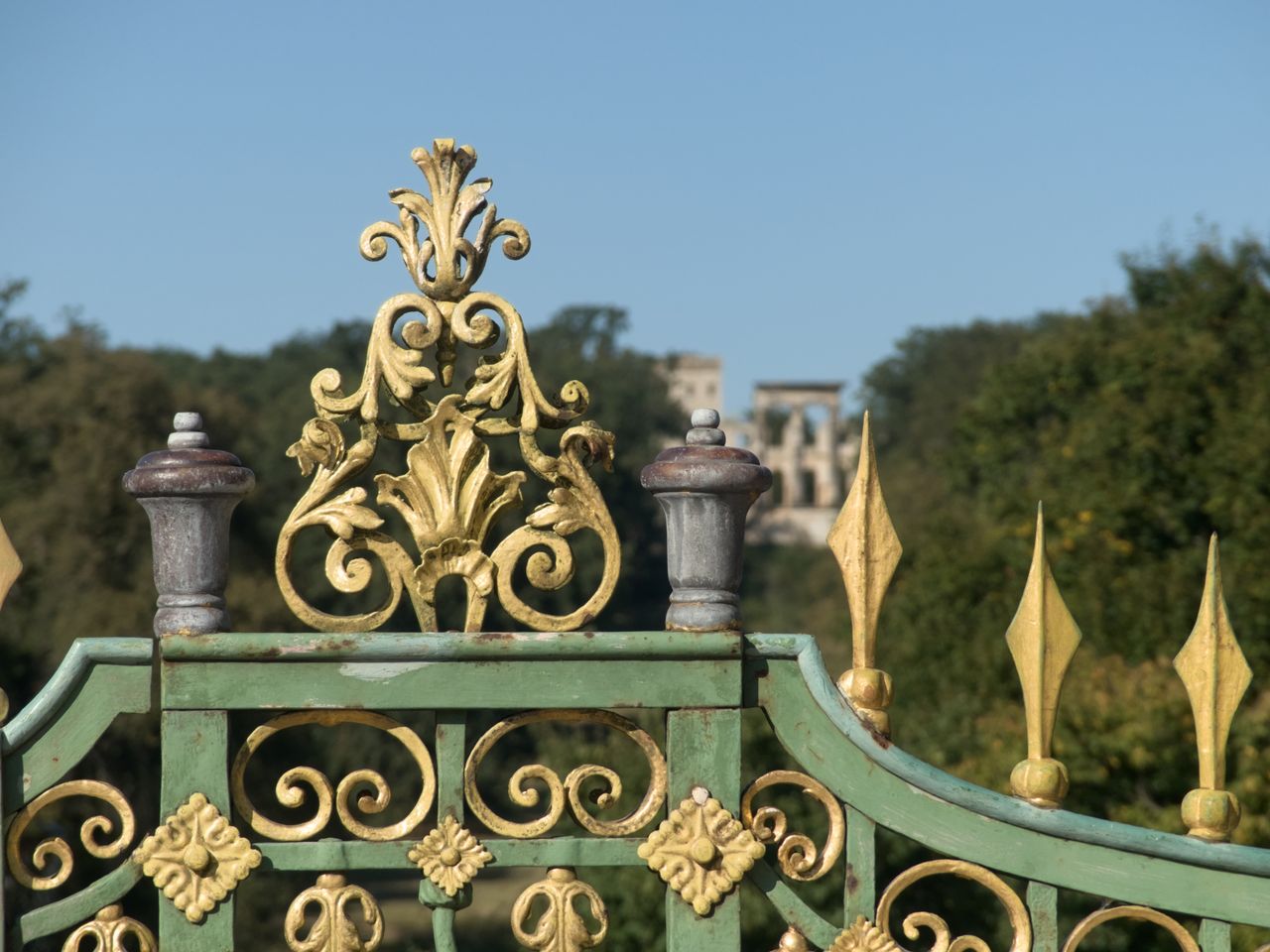 services-03 Close-up of an ornate green and gold gate at Park Sanssouci in Potsdam, Germany.