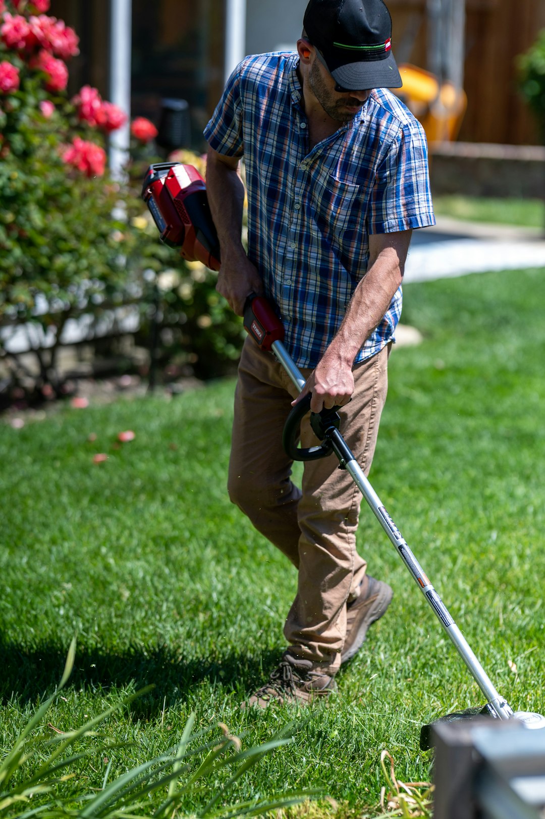 gallery-02 Man edging and weed eating a lawn with a battery powered edger