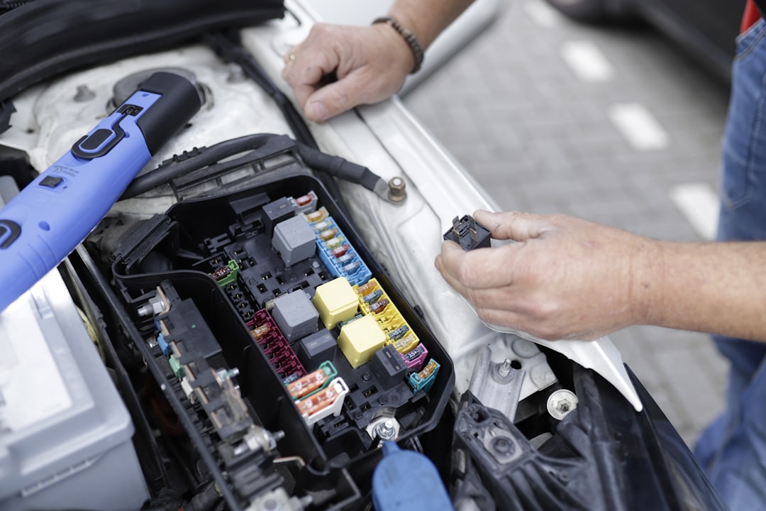 gallery-2 Car mechanic working on a cars electronics.