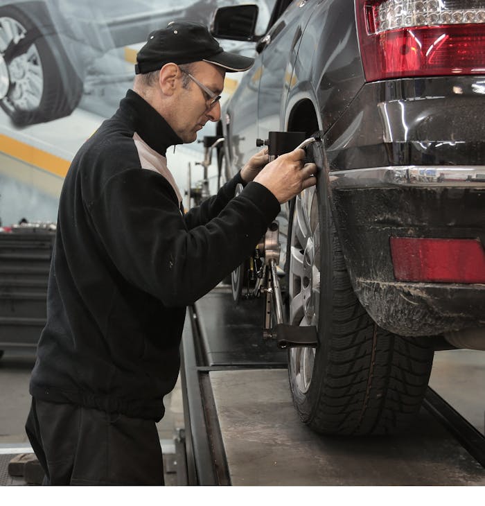 gallery-4 Professional mechanic adjusting wheel alignment for optimal performance in auto repair shop.